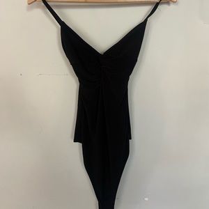 Pretty little things onsie top.  Never been worn.  Size xs